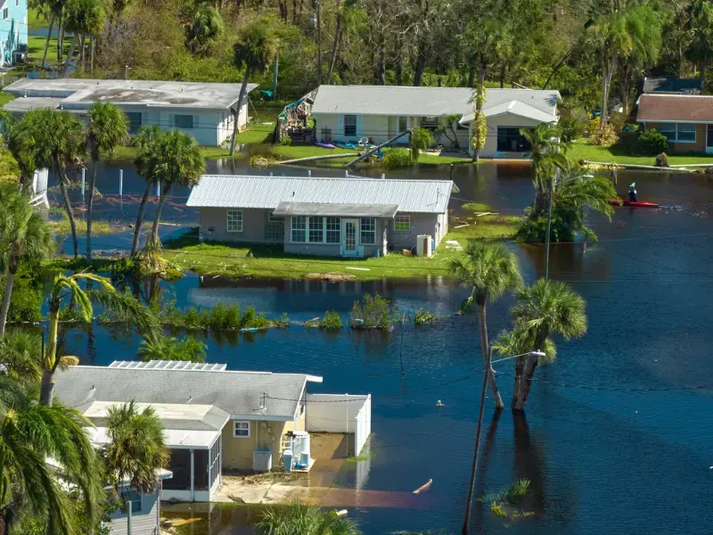 Aerial view of flooded Southwest Florida homes and palms after a hurricane
