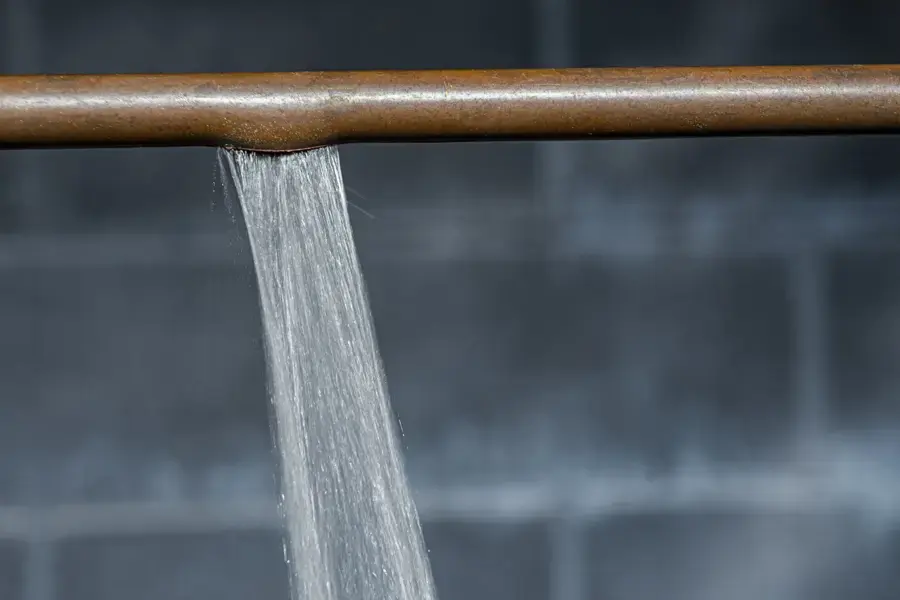 Water pouring from a split supply pipe