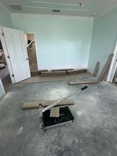 Flooring pulled up to expose a wet concrete slab in a North Port home